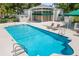 Community pool with lounge chairs and adjacent clubhouse at 5532 Country Club Way, Sarasota, FL 34243