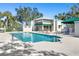 Community pool and clubhouse with surrounding lush greenery at 5532 Country Club Way, Sarasota, FL 34243