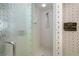 Shower stall with textured glass door and white tiled walls at 5532 Country Club Way, Sarasota, FL 34243