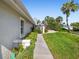 Sidewalk alongside the house with landscaping at 5532 Country Club Way, Sarasota, FL 34243