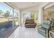 Sunroom with reclining chairs and view of backyard at 5532 Country Club Way, Sarasota, FL 34243