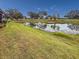 Backyard with pond, fountain and lush green grass at 5715 Spanish Point Ct, Palmetto, FL 34221