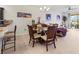 Dining area with glass-top table and four chairs, view to living room at 5715 Spanish Point Ct, Palmetto, FL 34221