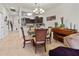 Open dining room with four chairs and a view into the living room and kitchen at 5715 Spanish Point Ct, Palmetto, FL 34221