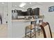 Kitchen breakfast bar with two stools and tan countertop at 5715 Spanish Point Ct, Palmetto, FL 34221