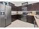 Modern kitchen with dark wood cabinets and stainless steel appliances at 5715 Spanish Point Ct, Palmetto, FL 34221