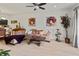 Living room with sectional sofa, wooden coffee table, and a ceiling fan at 5715 Spanish Point Ct, Palmetto, FL 34221