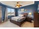 Main bedroom with a king-size bed and lake view at 5715 Spanish Point Ct, Palmetto, FL 34221