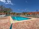 Community pool with brick deck and lounge chairs at 5715 Spanish Point Ct, Palmetto, FL 34221