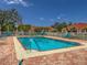 Community pool with brick deck and lounge chairs at 5715 Spanish Point Ct, Palmetto, FL 34221