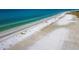 Drone view of Siesta Beach showing the white sand and ocean at 5780 Midnight Pass Rd # 609, Sarasota, FL 34242