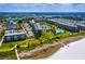 Aerial view of Gulf Bay Club, showing multiple buildings, pools, landscaping, and beach access at 5780 Midnight Pass Rd # 609, Sarasota, FL 34242