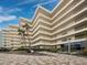 Multi-story building with balconies and palm trees at 5780 Midnight Pass Rd # 609, Sarasota, FL 34242