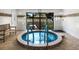 Indoor circular hot tub with tiled surround at 5780 Midnight Pass Rd # 609, Sarasota, FL 34242