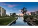 Peaceful waterfront view of canal and building at sunset at 5780 Midnight Pass Rd # 609, Sarasota, FL 34242