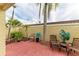 Private patio with brick pavers, comfortable seating and lush tropical landscaping at 6101 34Th W St # 28B, Bradenton, FL 34210