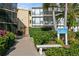 Sandpiper building exterior, showing walkway, landscaping, and building entrance at 618 Bird Bay S Dr # 206, Venice, FL 34285