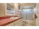 Bathroom with red tile countertop and shower at 6556 Waterford Cir, Sarasota, FL 34238