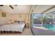 Bedroom with pool view, king-size bed, and access to a private patio at 6556 Waterford Cir, Sarasota, FL 34238