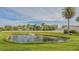 Community pond with fountain and lush landscaping at 6556 Waterford Cir, Sarasota, FL 34238