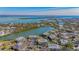 Drone view showcasing waterfront property, lush landscaping, and boat docks at 6750 Gulf Of Mexico Dr # 153, Longboat Key, FL 34228