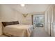 Bedroom with a queen-size bed and access to a private patio at 6750 Gulf Of Mexico Dr # 153, Longboat Key, FL 34228