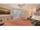 King-size bed and large TV in this well-lit bedroom at 6750 Gulf Of Mexico Dr # 153, Longboat Key, FL 34228