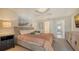 Bedroom with king-size bed, TV, and access to bathroom at 6750 Gulf Of Mexico Dr # 153, Longboat Key, FL 34228