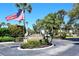 Community entrance with Whitney Beach signage at 6750 Gulf Of Mexico Dr # 153, Longboat Key, FL 34228