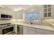 Modern kitchen with stainless steel appliances and white cabinetry at 6750 Gulf Of Mexico Dr # 153, Longboat Key, FL 34228