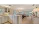 Condo kitchen with white cabinets, granite countertops, and breakfast bar at 6750 Gulf Of Mexico Dr # 153, Longboat Key, FL 34228