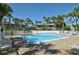 Community pool with surrounding patio at 6750 Gulf Of Mexico Dr # 153, Longboat Key, FL 34228