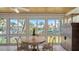 Bright sunroom with water views and a small table for two at 6750 Gulf Of Mexico Dr # 153, Longboat Key, FL 34228