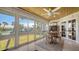 Sunroom with water views and dining table for four at 6750 Gulf Of Mexico Dr # 153, Longboat Key, FL 34228