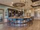 Upscale community bar with a curved bar top and teal barstools at 6819 Grand Estuary Trl # 102, Bradenton, FL 34212