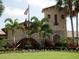 Elegant clubhouse entrance with landscaping and fountain at 6819 Grand Estuary Trl # 102, Bradenton, FL 34212