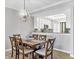 Dining room with wood table, chandelier, and seating for six at 6819 Grand Estuary Trl # 102, Bradenton, FL 34212