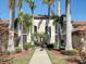 Exterior view of condo building with palm trees and walkway at 6819 Grand Estuary Trl # 102, Bradenton, FL 34212