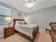 Cozy guest bedroom with a queen bed and nightstand at 6819 Grand Estuary Trl # 102, Bradenton, FL 34212