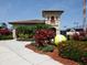 Attractive tennis center with landscaping and a large tennis ball at 6819 Grand Estuary Trl # 102, Bradenton, FL 34212