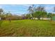 Green backyard with a house and pool visible in the distance at 7510 16Th Nw Ave, Bradenton, FL 34209