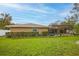 Yard with a tan house, hedges, and screened-in pool area at 7510 16Th Nw Ave, Bradenton, FL 34209