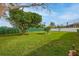 Backyard with large trees, lush grass and a partial house view at 7510 16Th Nw Ave, Bradenton, FL 34209