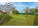 Large grassy backyard with mature trees and a chain link fence at 7510 16Th Nw Ave, Bradenton, FL 34209