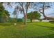 Spacious backyard with lush grass, mature trees, and a fenced perimeter at 7510 16Th Nw Ave, Bradenton, FL 34209