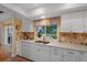 Modern kitchen with white cabinets, quartz countertops, and a view of the pool at 7510 16Th Nw Ave, Bradenton, FL 34209