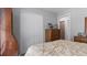 Bedroom with double doors closet and wooden dresser at 7664 39Th Street E Cir, Sarasota, FL 34243