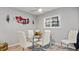 Dining area with glass table and white chairs at 7664 39Th Street E Cir, Sarasota, FL 34243