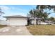 White house with gray roof, landscaping, and a two-car garage at 7664 39Th Street E Cir, Sarasota, FL 34243