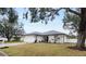 Landscaped yard with a white house and gray roof at 7664 39Th Street E Cir, Sarasota, FL 34243